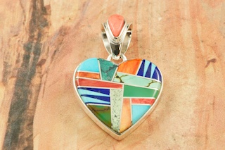 Genuine Turquoise, Spiny Oyster Shell and Blue Lapis inlaid between ribbons of Sterling Silver. Beautiful Heart Design Pendant.  Free 18" Sterling Silver Chain with purchase of pendant. Designed by Navajo Artist Calvin Begay. Signed. 
